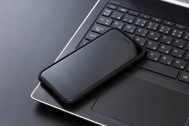 istock Laptop and smartphone on a black background. 2198333535