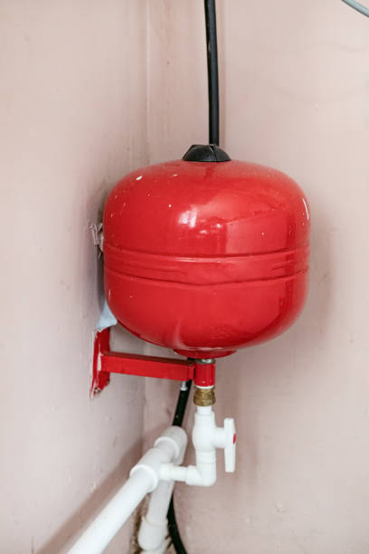 istock Heating boiler tank. Room with heating equipment. Gas boiler technologies. Heating system country house. Boiler tank at wooden wall. Gas equipment to maintain temperature. Engineering communications 2198335571