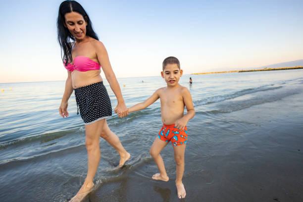 istock Mother and Son Taking a Walk on the Shore 2198335746