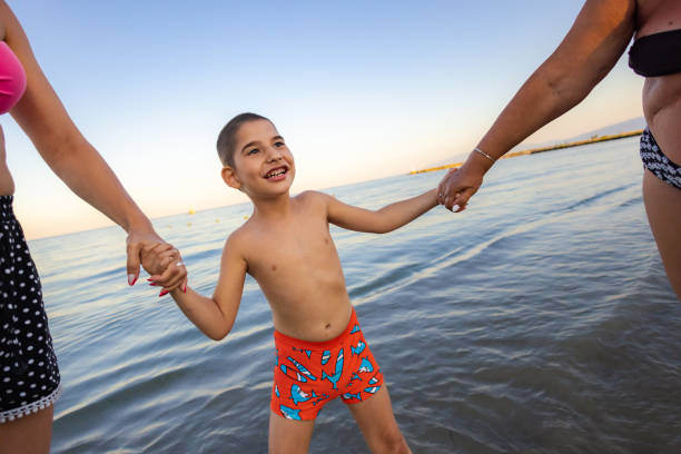 istock Happy Family Beach Walk 2198335991