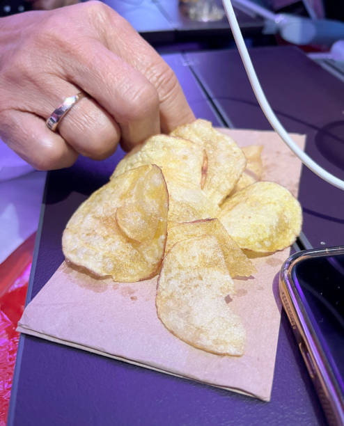 istock Woman snacking on potato chips on plane 2198336128