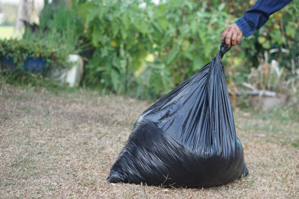 istock Closeup hand holds black plastic bag that contains garbage inside. Concept , Waste management. Environment problems. Daily chores. Throw away rubbish. Sorting type of garbage. 2198336351