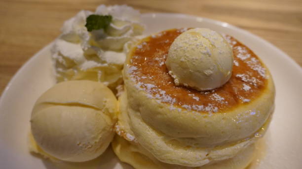 istock pancake souffle with vanilla ice cream and whipped cream in white plate 2198338111