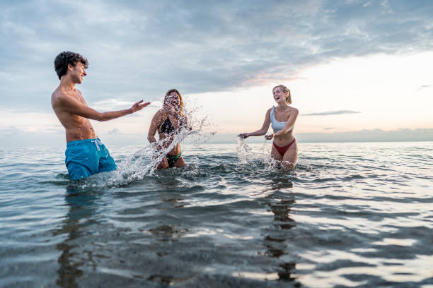 istock Friends having fun in the sea 2198338463