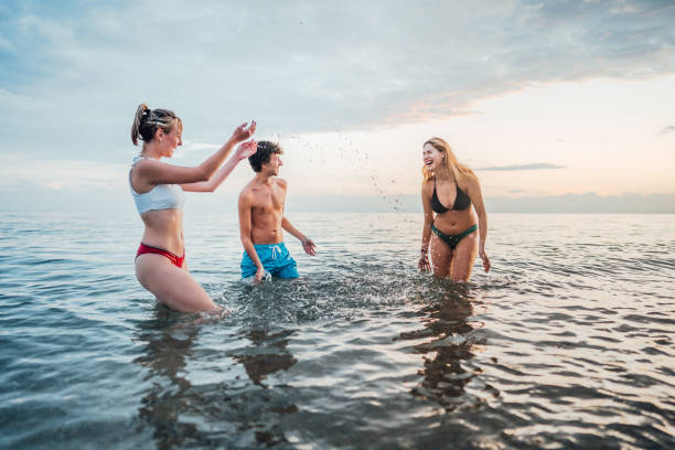 istock Friends having fun in the sea 2198338678