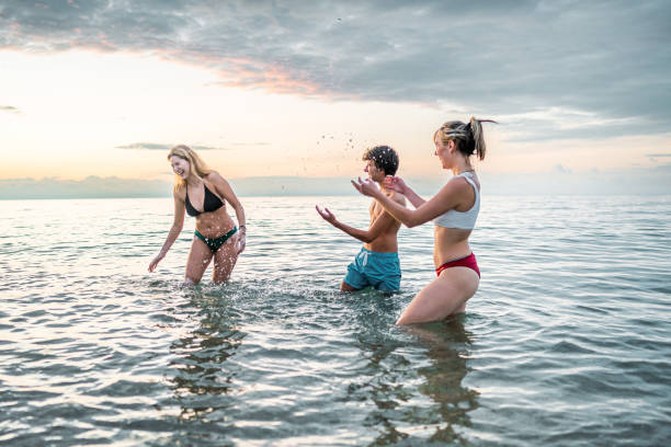istock Playful friends having fun together in the sea 2198339036