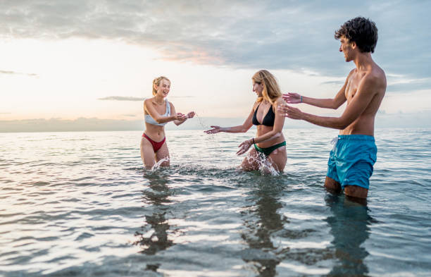istock Friends having fun in the sea 2198339214