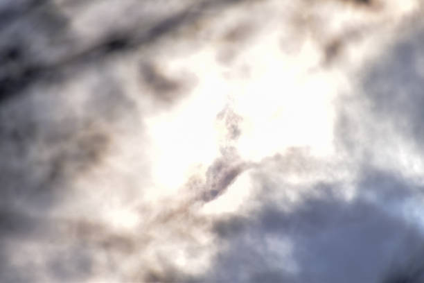 Cloudscape with clouds covering the sun under the blue sky. Nature scene, skyscape and cloudscape.