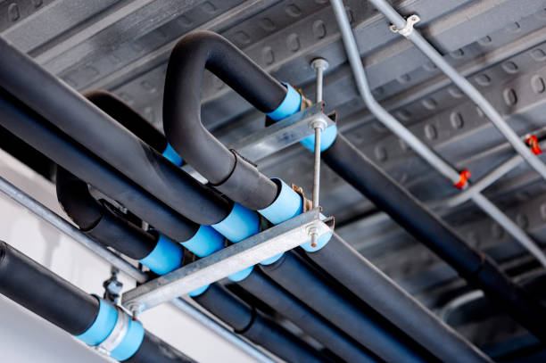 istock Group of black plumbing pipe on metal ceiling. pipeline connection for water system 2198342381