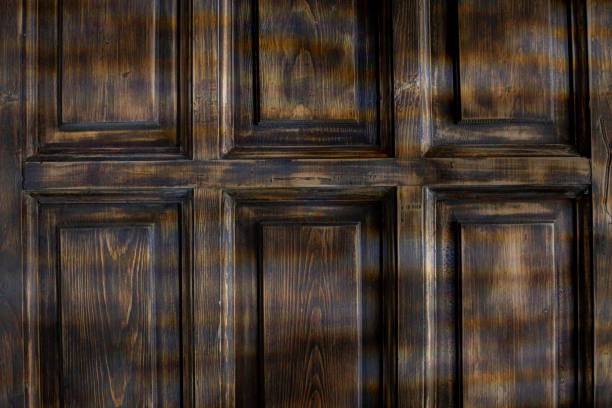 This dark wooden panel texture is ideal for various backgrounds and design elements across multiple media