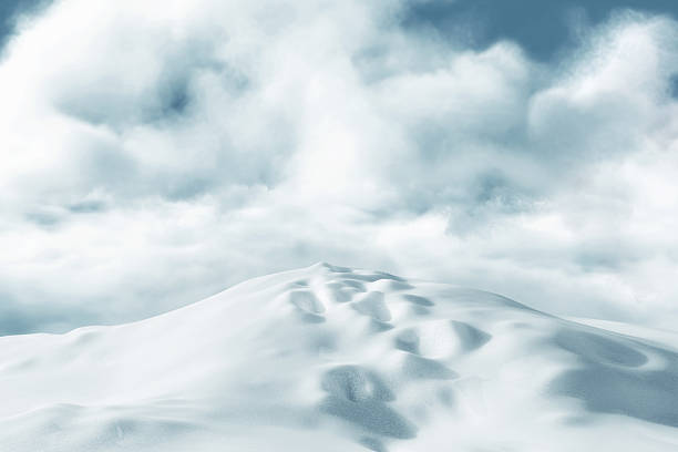 istock 3D Rendering of snow-covered hill with snow tracks in front fog and clouds 2198343545