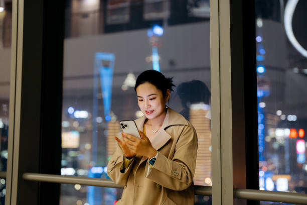istock Asian businesswoman using smart phone at night. 2198346709
