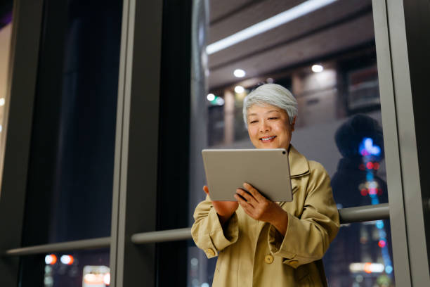 istock Asian senior businesswoman using digital tablet at night. 2198346741