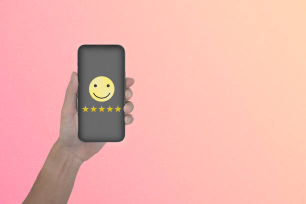 istock Business man work with smartphone have customer satisfaction score five  icon are floating on screen 2198349790