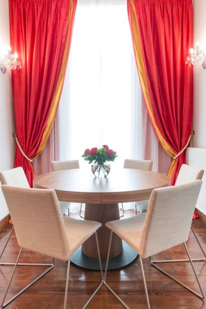 istock Elegant Dining Area with Red Curtains 2198353643