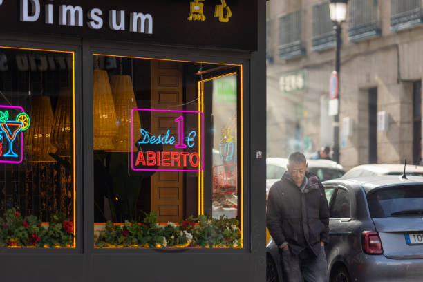 Chinese Restaurant on Calle Leganitos, Madrid, Spain. A cozy Chinese restaurant on Calle Leganitos, Madrid, featuring warm lighting and neon signs that invite customers inside. The glowing \