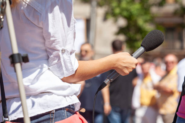 istock Female journalist making media or vox pop interview with unrecognizable person 2198357950