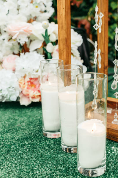 istock Glass candle holders with white wax candles 2198358600