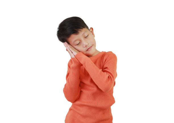 Portrait Asian boy kid making sleep posture on white isolated studio background.