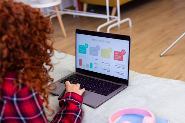 istock Woman working from home analyzing marketing strategy on laptop 2198362917