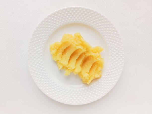 plate of mashed potatoes and fork, close-up