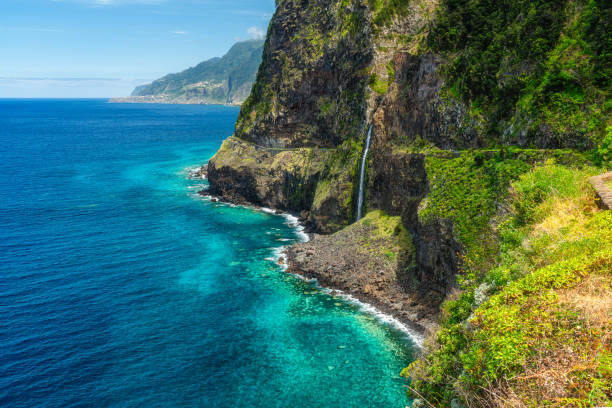 istock Panoramic view from Miradouro do Veu da Noiva, with a scenographic waterfall, on Madeira island, Portugal. 2198370929