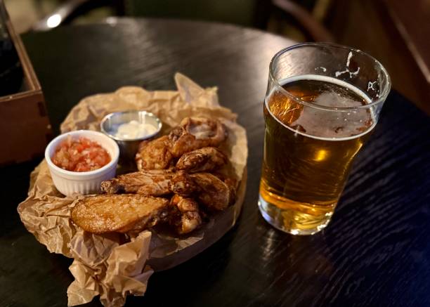 Indulge in Delicious Chicken Wings and Beer While Enjoying the Cozy and Inviting Setting