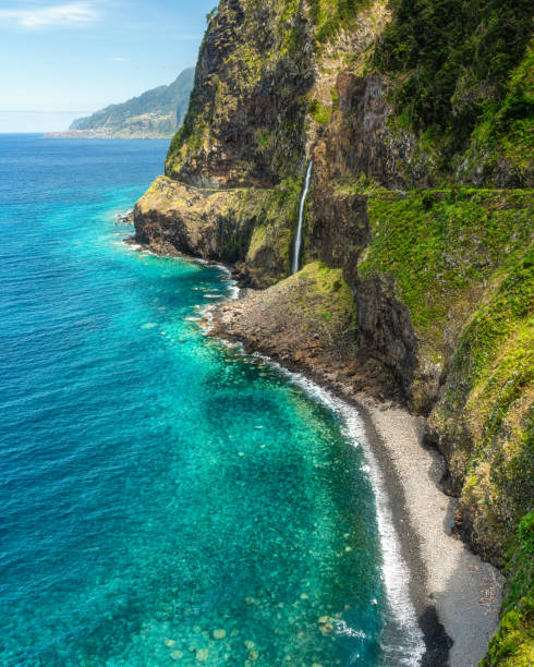istock Panoramic view from Miradouro do Veu da Noiva, with a scenographic waterfall, on Madeira island, Portugal. 2198371055