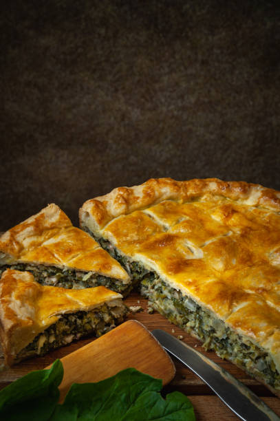 istock Vegetable pie homemade baking with spinach and onions, on a dark wooden 2198371579