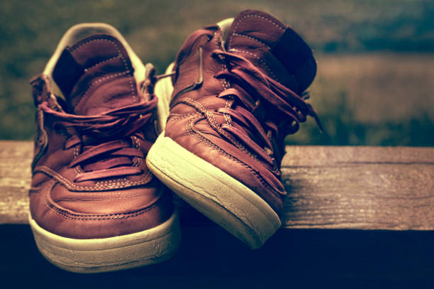 istock Sneakers on a wooden  abstract background with vintage 2198372597