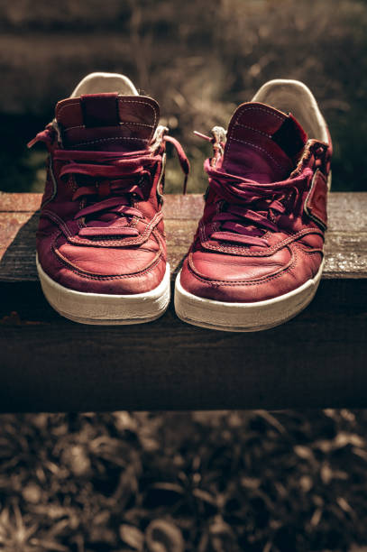 istock Old sneakers tinted on a wooden  abstract 2198372600