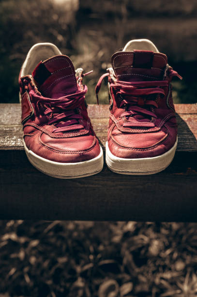 istock Old neakers tinted on a wooden  abstract 2198372601