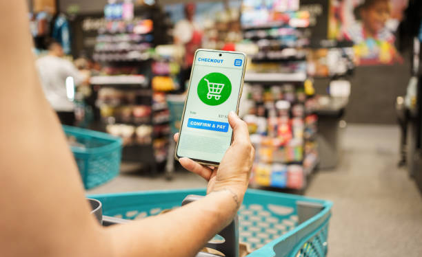 istock Person Using Smartphone To Complete Mobile Payment At Grocery Store 2198373895