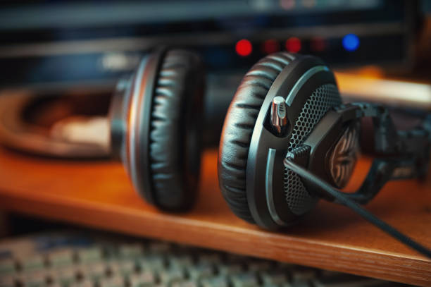 istock Headphones on a computer desk with dark 2198375200