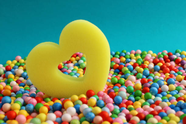 Openwork sponge heart surrounded by colorful spheres