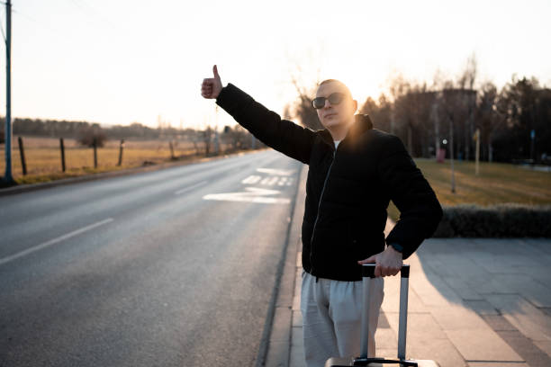 a guy is hitchhiking because his bus ran away