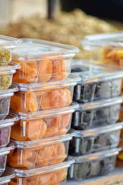 istock Assorted dried fruits in clear plastic containers at market 2198382742