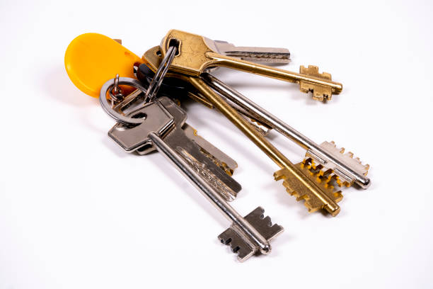 Car key and mini pocketknife on blue wooden table