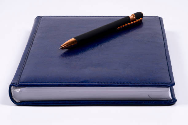 istock Elegant blue notebook with a stylish pen on a clean surface 2198383511