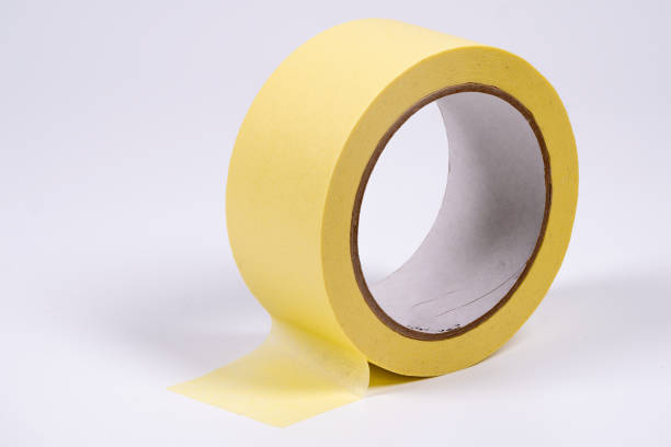 istock Yellow masking tape roll on white background highlighting adhesive quality 2198384083