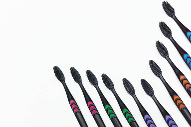 istock Black toothbrushes with colored stripes for cleaning 2198384556
