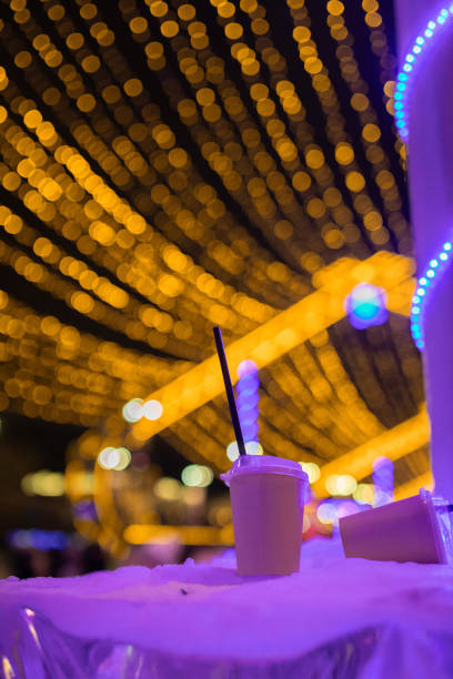 Disposable cups scattered in a city park during the New Year festivities, reflecting the seasonal outdoor celebrations.