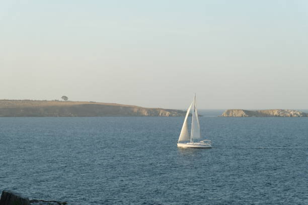 Fishing boat in Lorbé harbor, A Coruña province, Rías Altas, Galicia, Spain. Forest , cliff, turquoise water.