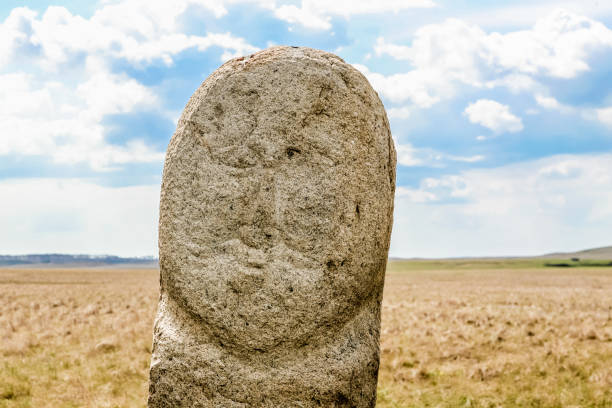 Arkaim in Ural Russia. A large stone baba with a face carved into it. The face is of a man with a beard