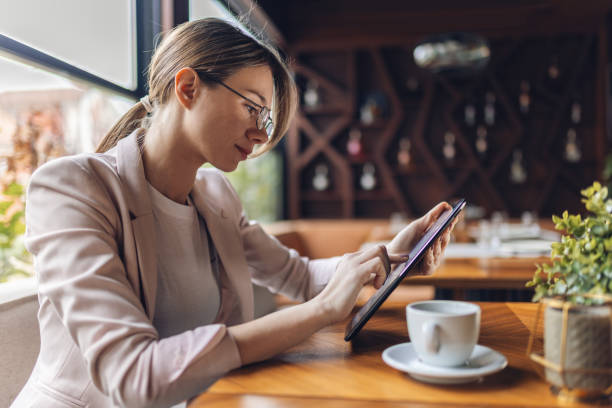 istock Business woman typing on her tablet 2198390569