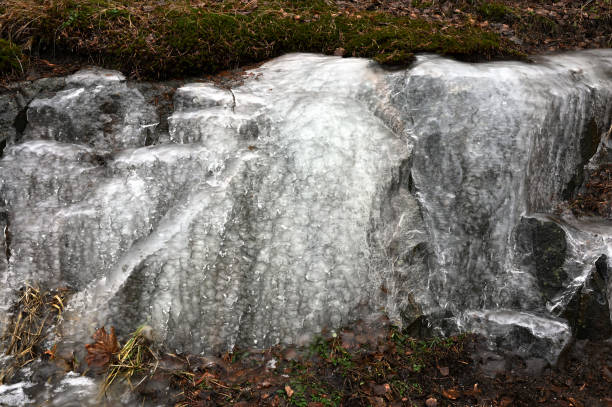 istock A striking close-up of ice formations cascading over rugged rocks, creating intricate textures and patterns 2198392497