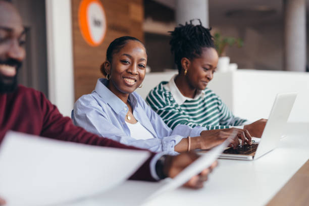istock Young African American business team working together on a project 2198392877