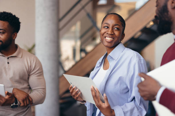 istock Young businesspeople discussing work holding digital tablets and smiling 2198392989