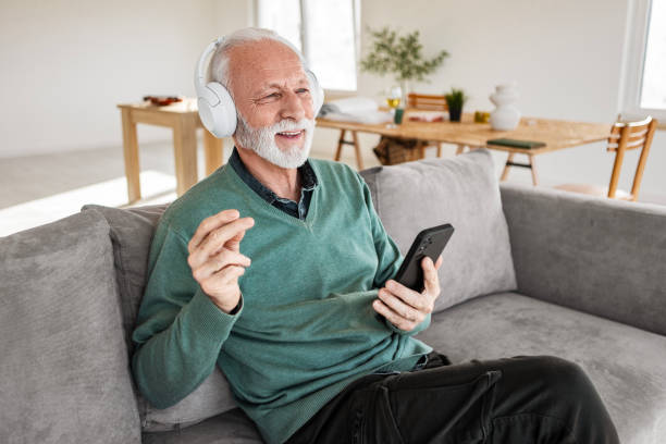 istock Elderly Man Enjoying Smartphone with Headphones 2198393016