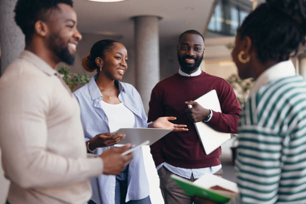 istock Young african american colleagues discussing a project in the office hall 2198393242